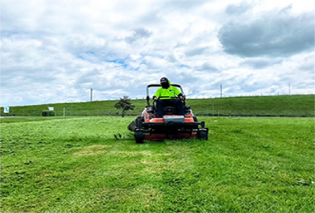 Holland Landscaping crew mowing the sports field on an Auckland sports complex maintained by Holland Landscaping